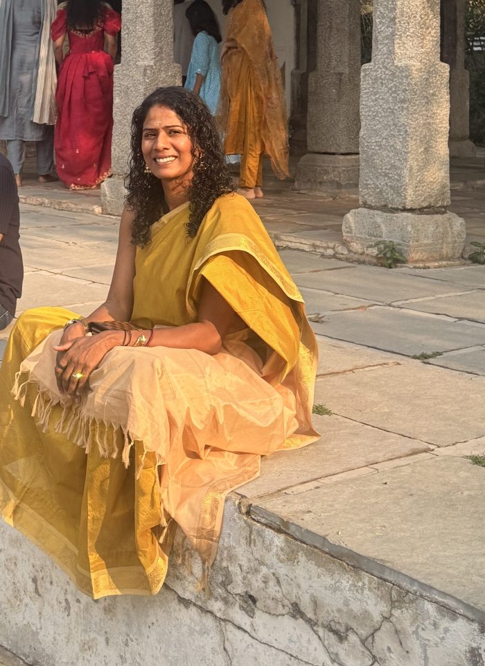 Sitting at Rama temple in a yellow saree, quiet moment